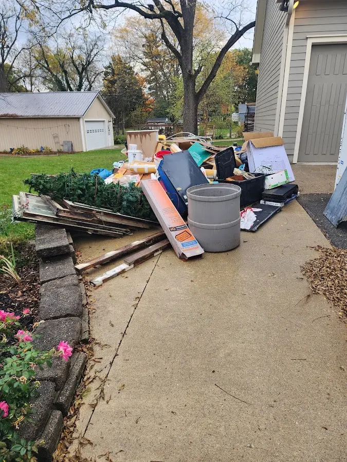 Dumpster being loaded with debris for Estate Cleanout Dumpster Rental in Coldwater